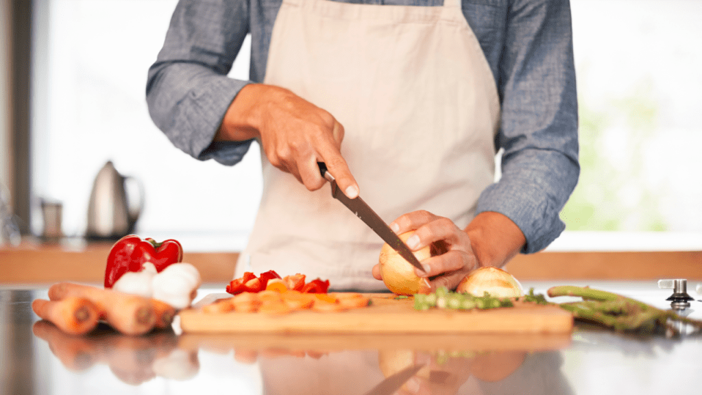 person slicing vegetable ingredients