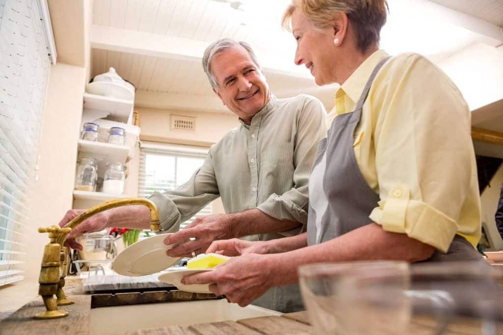 old couple washing dishes