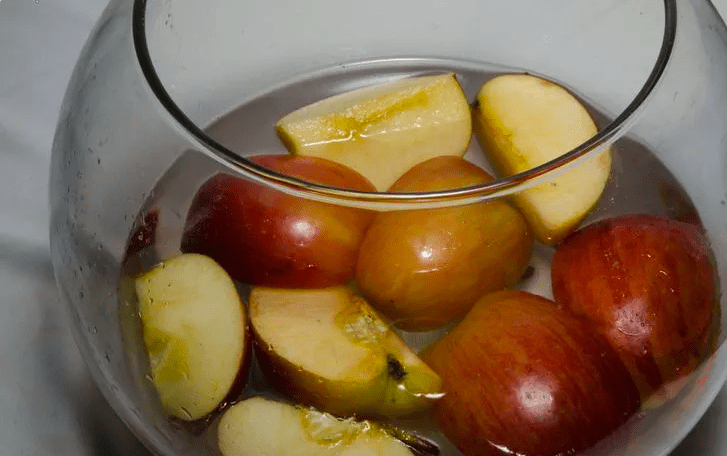 water and apples in jar