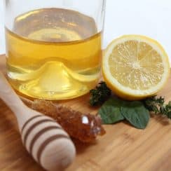 a glass of honey and lemon