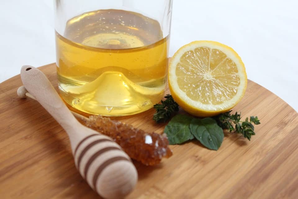 a glass of honey and lemon