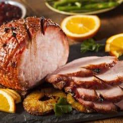 honey coated ham with sliced lemon and pineapple