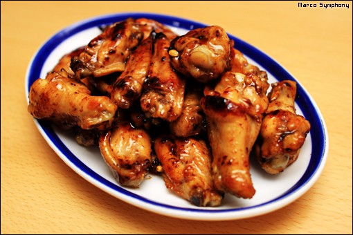 a plateful of chicken wings drizzled with honey mixture