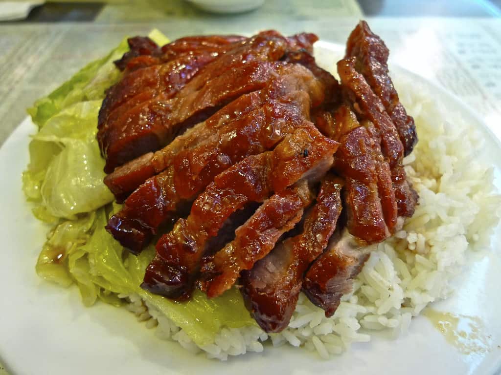 a plate of pork BBQ with rice and cabbage