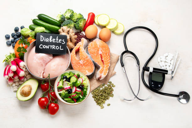 Blood-Sugar-Control-001-003 Top view of healthy food in plate with stethoscope, cholesterol diet and diabetes control on white background. World health day and medical concept.
