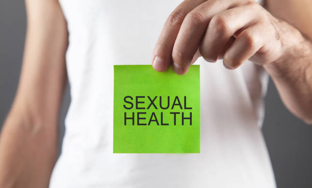 Man showing Sexual Health text in sticky note.