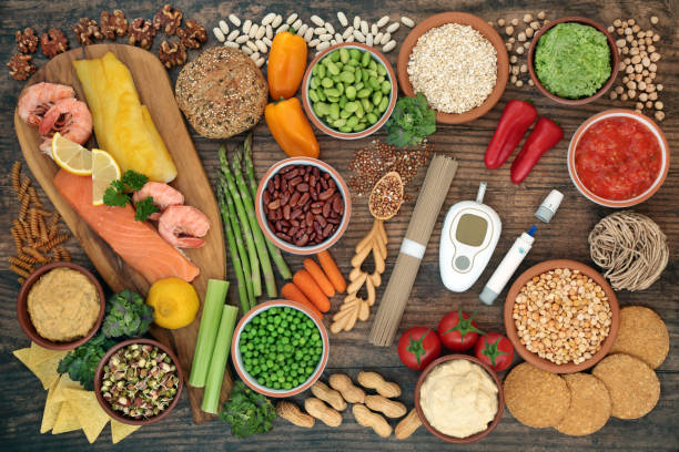 Foods-for-Better-Blood-Sugar-001 Low glycemic testing & lancing devices with healthy food for diabetics below 55 on the GI index. High in antioxidants, anthocyanins, vitamins, minerals, protein, fibre, omega 3 & smart carbs. Flat lay on wood.