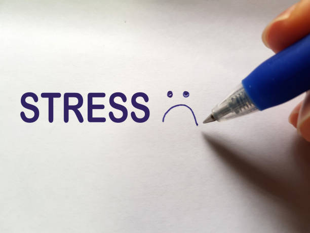 Stress-and-High-Blood-Sugar-002-01 A hand writing the word STRESS with sad emoticon