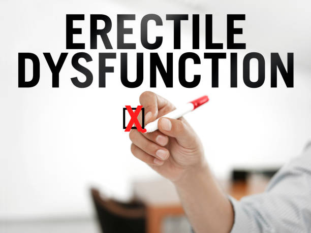 Patient writing “Erectile dysfunction” on a transparent wipe board.
