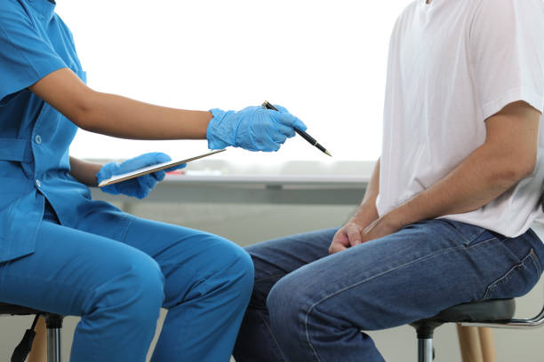 Doctor is diagnosing male erectile dysfunction and giving treatment recommendations, male health problems.