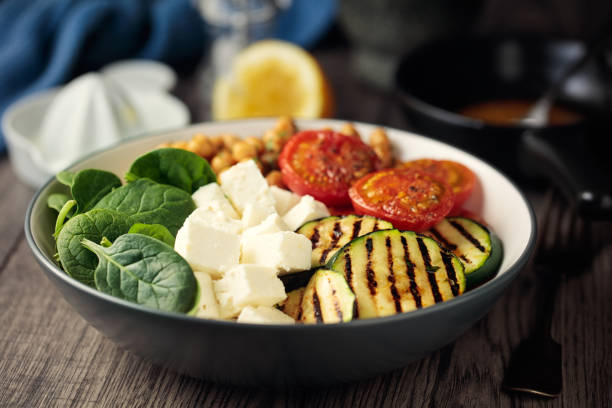 Home made freshness grilled courgette,tomato,spicy chickpea and spinach with feta cheese in a bowl