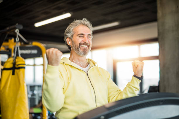 Happy mature men getting those gains in the gym.