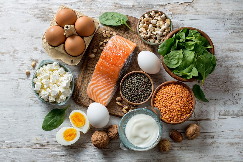 Healthy protein foods including eggs fish beans and yogurt