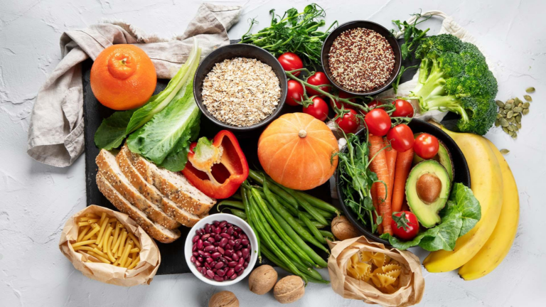 Healthy balanced meal with vegetables, fruits, whole grains, and protein