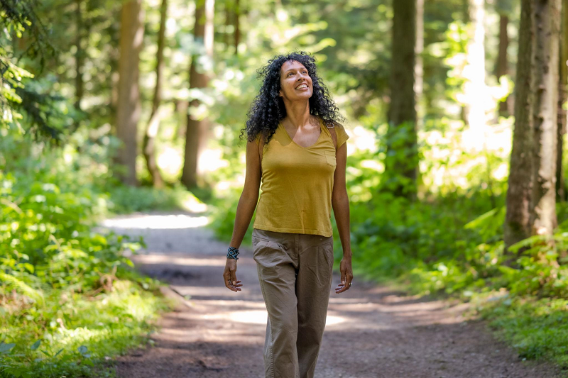 Person enjoying a healthy walk outdoors in nature