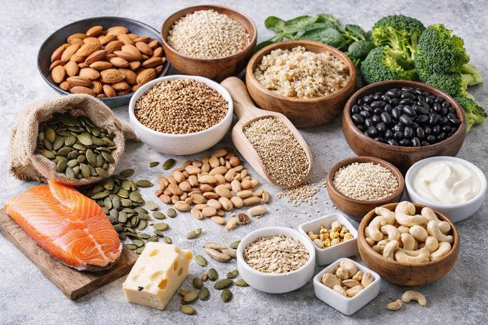 Whole grains and healthy protein foods including oats, quinoa, beans, fish, and nuts